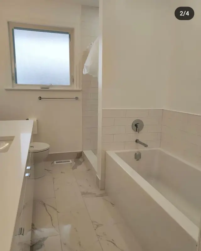 Bathroom with a new tiled tub surround and vanity