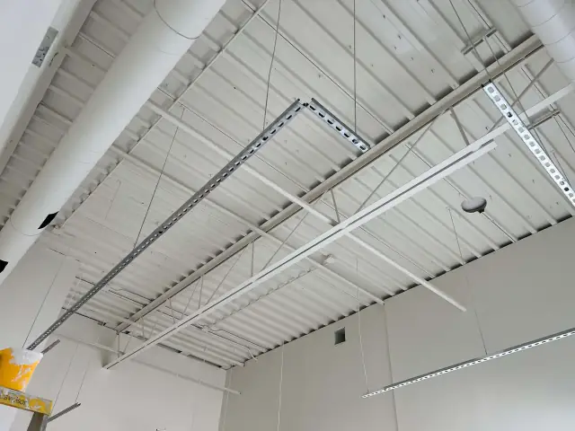 Commercial space with painted open ceiling and new lighting runs